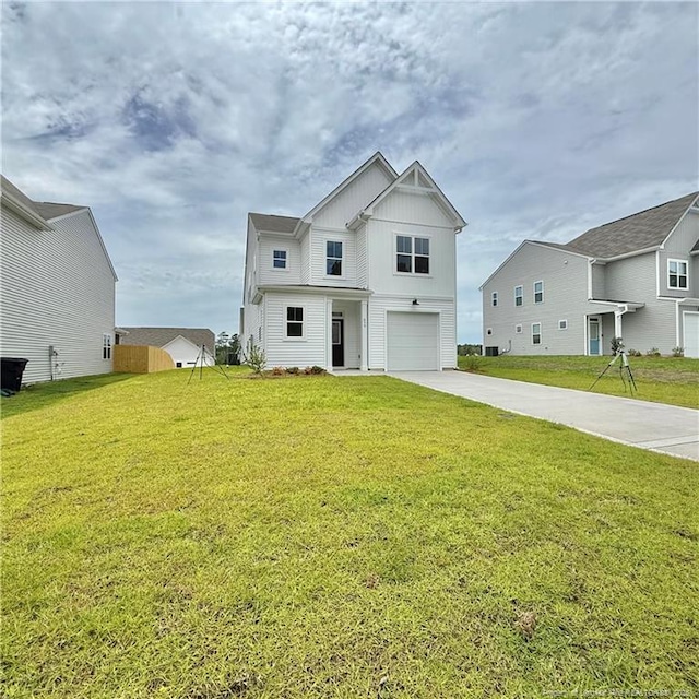 659 Union St, Home, Raeford, NC 28376 - view of front of property featuring board and batten siding, a garage, driveway, and a front yard