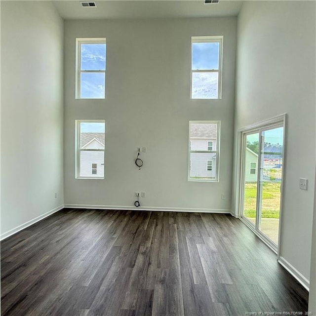 659 Union St, Home, Raeford, NC 28376 - unfurnished room featuring dark wood-type flooring, a high ceiling, and healthy amount of natural light