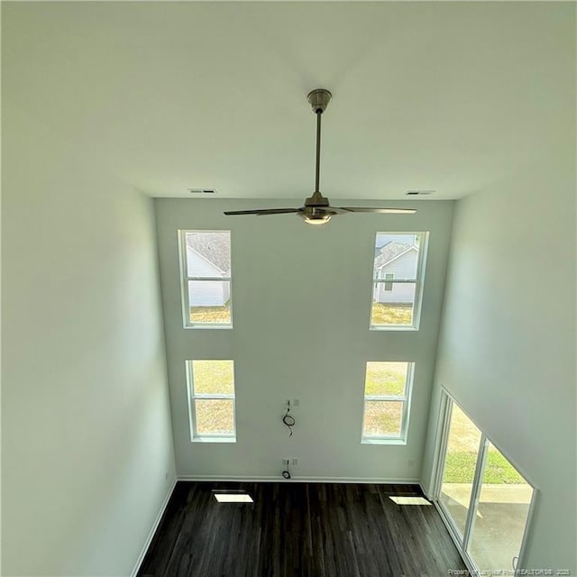 659 Union St, Home, Raeford, NC 28376 - unfurnished room featuring dark wood-style flooring, healthy amount of natural light, ceiling fan, and a towering ceiling