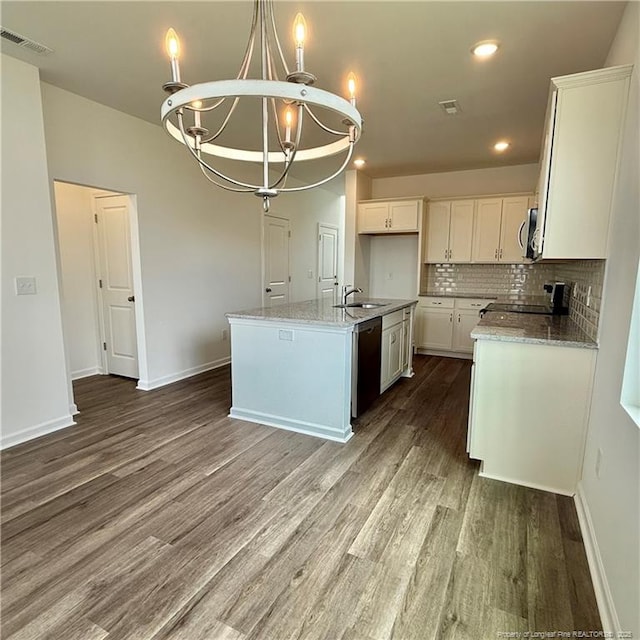 659 Union St, Home, Raeford, NC 28376 - kitchen featuring stainless steel microwave, dishwashing machine, wood finished floors, a chandelier, and white cabinets