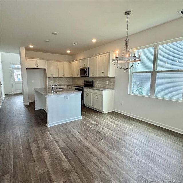 659 Union St, Home, Raeford, NC 28376 - kitchen with stainless steel appliances, a chandelier, white cabinetry, healthy amount of natural light, and recessed lighting