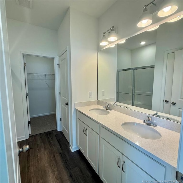659 Union St, Home, Raeford, NC 28376 - full bathroom with a shower stall, wood finished floors, double vanity, and a spacious closet
