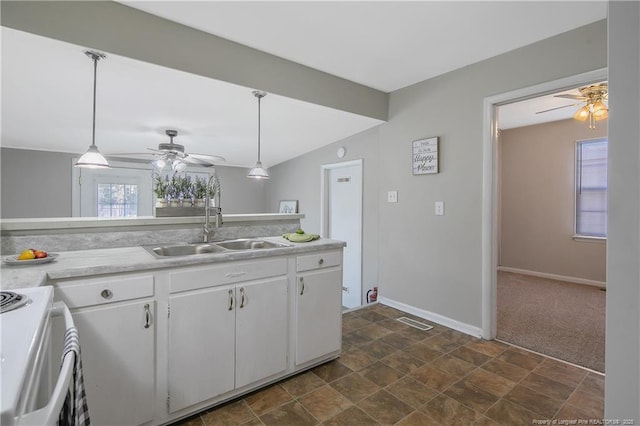 kitchen featuring white cabinetry, visible vents, a sink, and stove