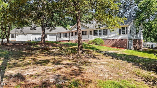 exterior space with crawl space and a garage