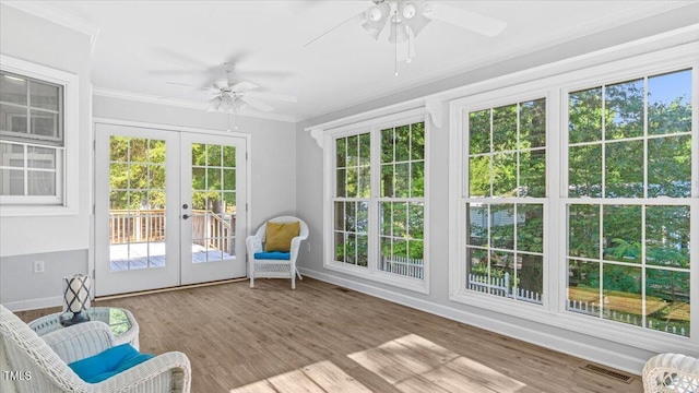 unfurnished sunroom with french doors, visible vents, and ceiling fan