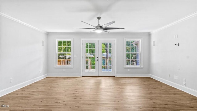 interior space featuring french doors, crown molding, baseboards, and wood finished floors