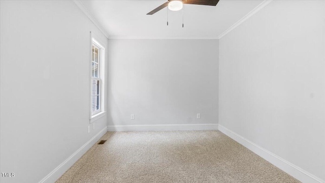 empty room featuring carpet, baseboards, ceiling fan, and crown molding