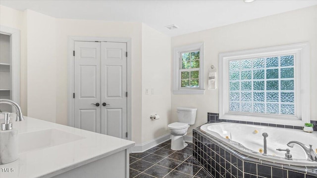 bathroom featuring toilet, visible vents, a jetted tub, and a closet