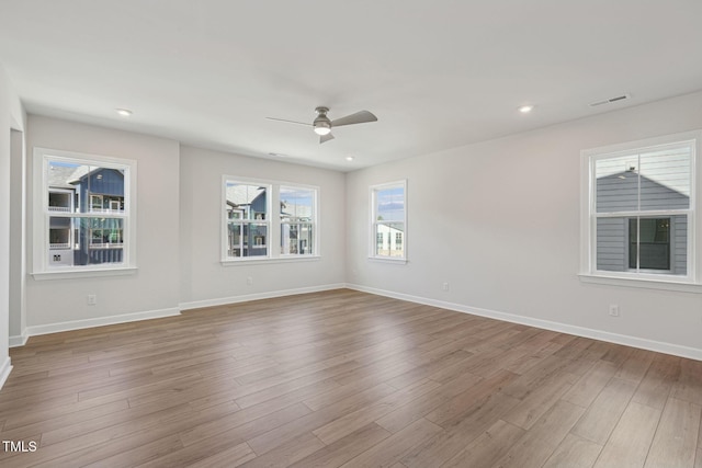 spare room featuring ceiling fan, recessed lighting, wood finished floors, and baseboards