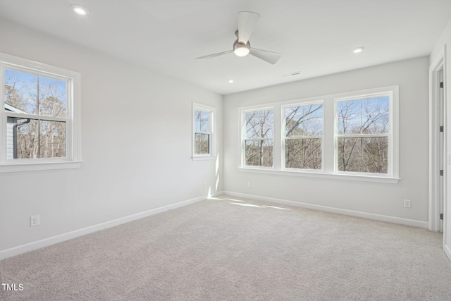 carpeted spare room featuring ceiling fan, recessed lighting, visible vents, and baseboards