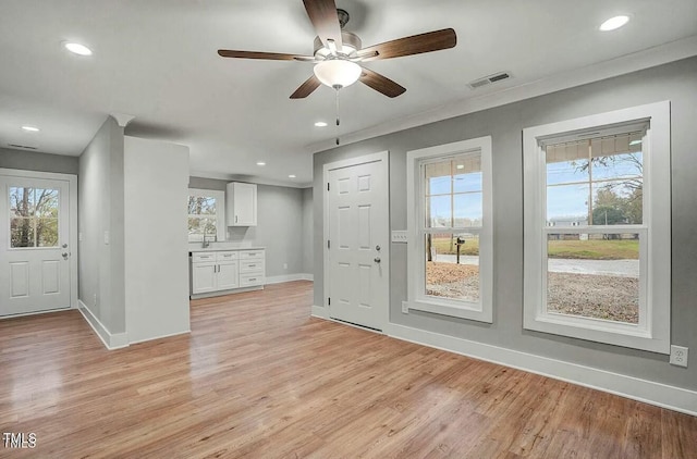 unfurnished living room with light wood-style floors, baseboards, visible vents, and recessed lighting