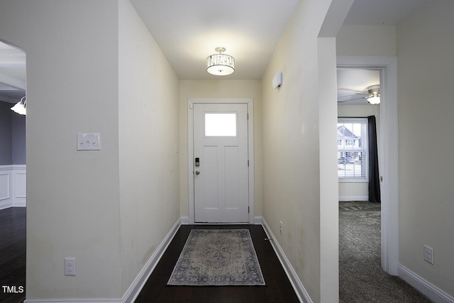 entryway featuring baseboards and arched walkways