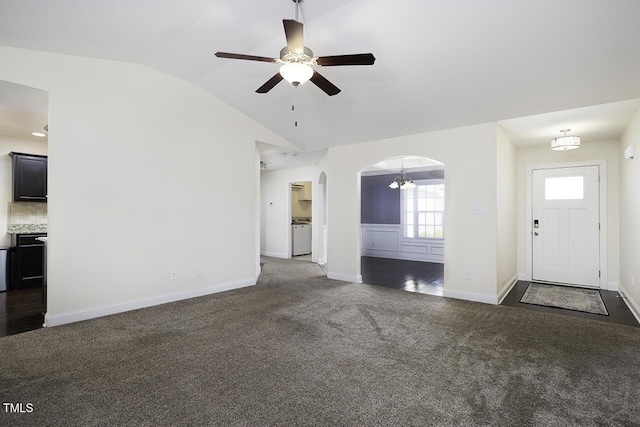 unfurnished living room featuring arched walkways, baseboards, ceiling fan, carpet, and vaulted ceiling