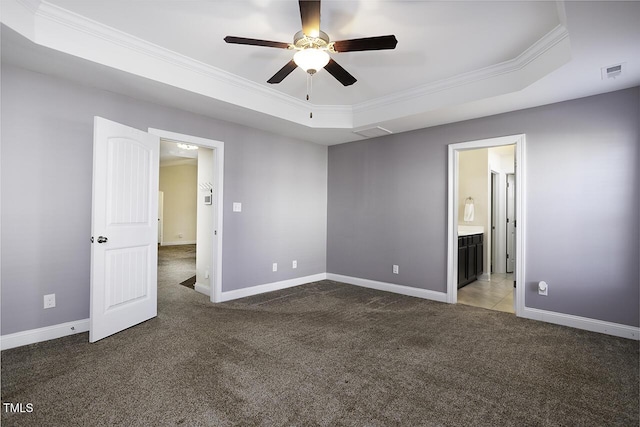 unfurnished bedroom with carpet floors, visible vents, a raised ceiling, and ornamental molding