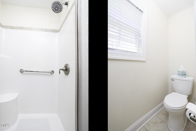 full bathroom with tile patterned floors, baseboards, toilet, and walk in shower