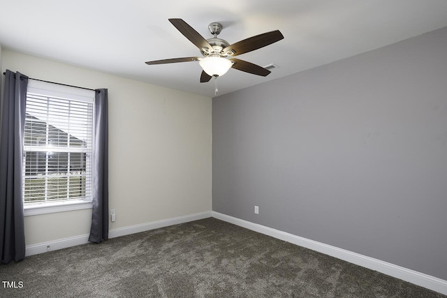 carpeted spare room featuring a ceiling fan, visible vents, and baseboards