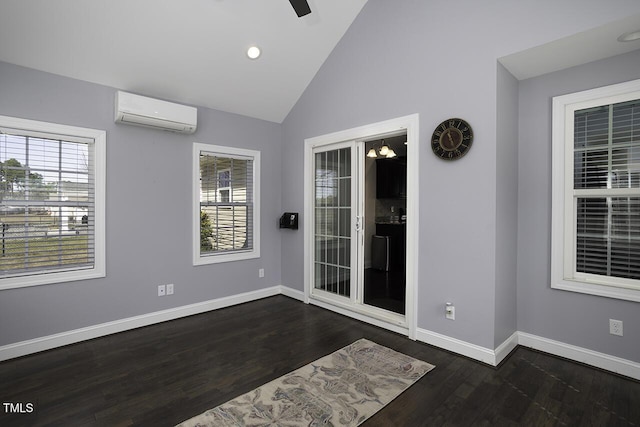 entryway featuring baseboards, an AC wall unit, lofted ceiling, and a healthy amount of sunlight