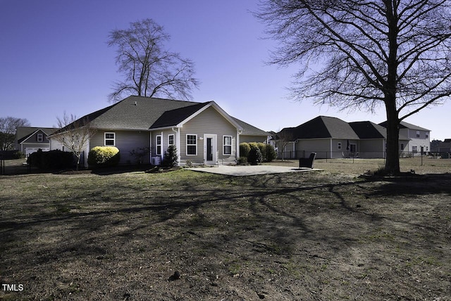 back of property with fence and a patio