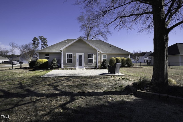 rear view of property with a patio and fence