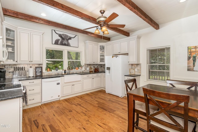 kitchen featuring white appliances, light wood-type flooring, a sink, and decorative backsplash