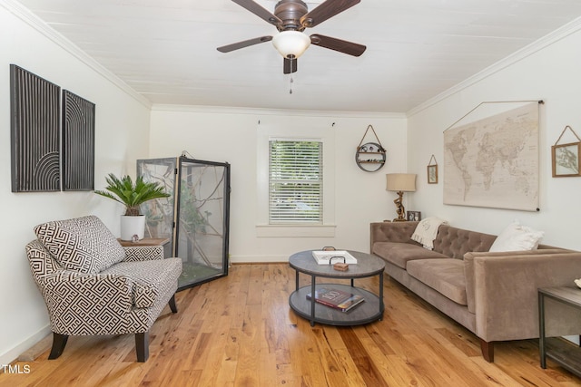 living room with baseboards, a ceiling fan, crown molding, and wood finished floors