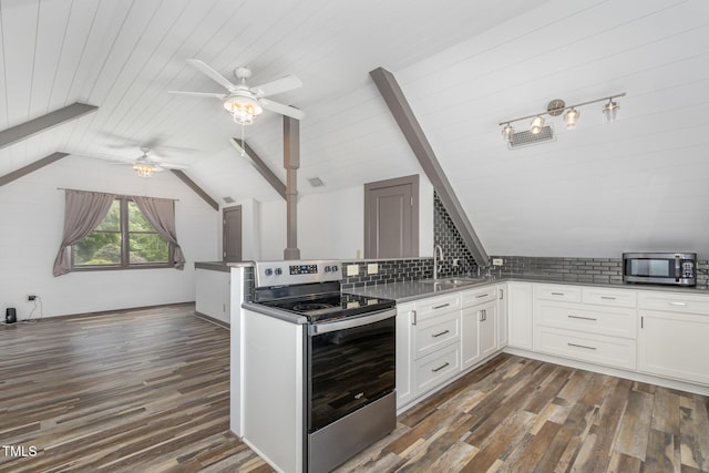 kitchen featuring a peninsula, white cabinetry, appliances with stainless steel finishes, and dark wood-type flooring