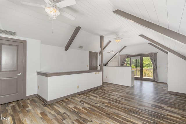 interior space with visible vents, baseboards, ceiling fan, wood finished floors, and vaulted ceiling with beams