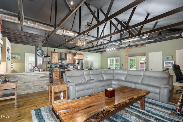 living room with a notable chandelier, visible vents, light wood-style floors, high vaulted ceiling, and beamed ceiling