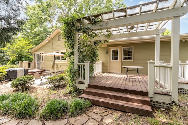 wooden terrace with grilling area and a pergola