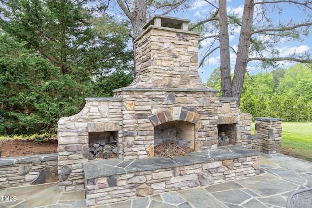 view of patio featuring an outdoor stone fireplace