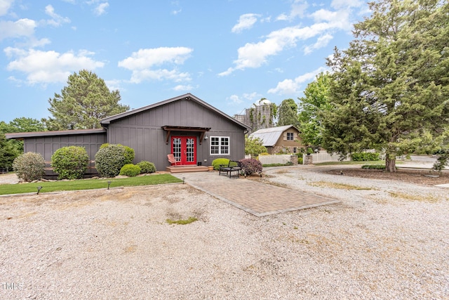 view of front of house with french doors and fence