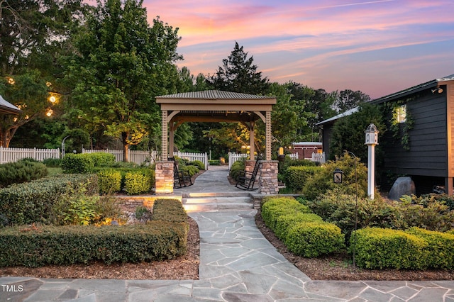 view of home's community with a gazebo and fence