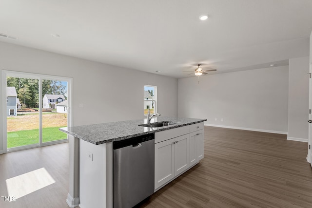 kitchen with visible vents, stainless steel dishwasher, white cabinetry, a sink, and wood finished floors