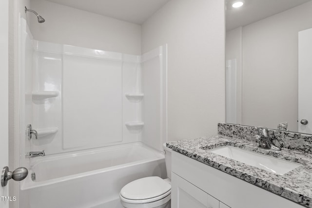 bathroom with washtub / shower combination, vanity, and toilet