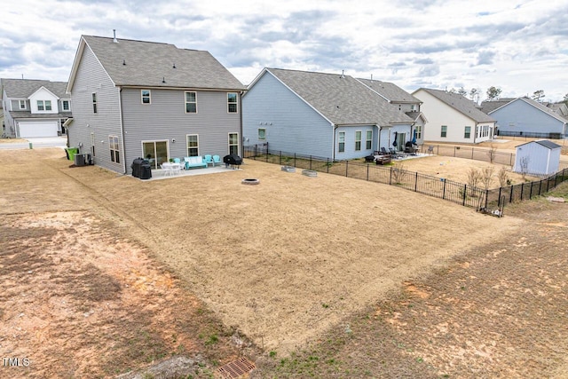 back of property featuring a patio, fence, a residential view, and central air condition unit