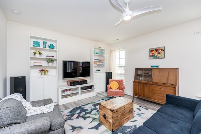 living area with ceiling fan and wood finished floors