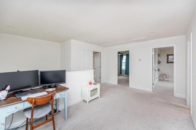 home office with visible vents, baseboards, and light colored carpet