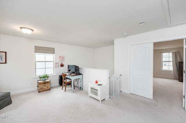 office with light carpet, attic access, and baseboards