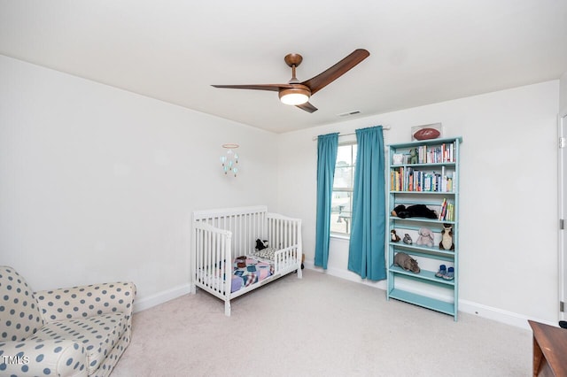 carpeted bedroom with a ceiling fan, visible vents, and baseboards