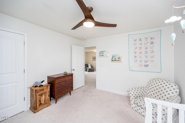 bedroom with light colored carpet, ceiling fan, and baseboards