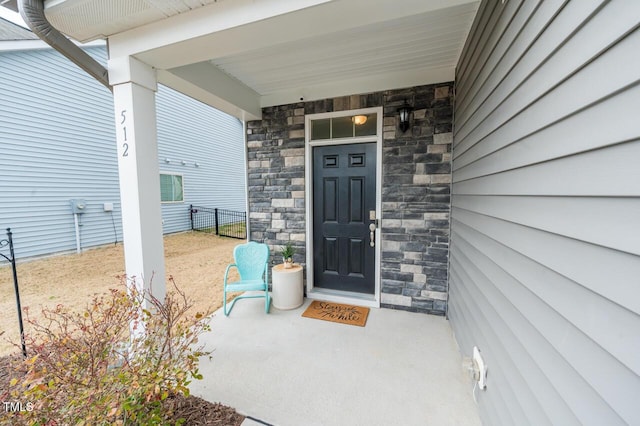 entrance to property featuring stone siding