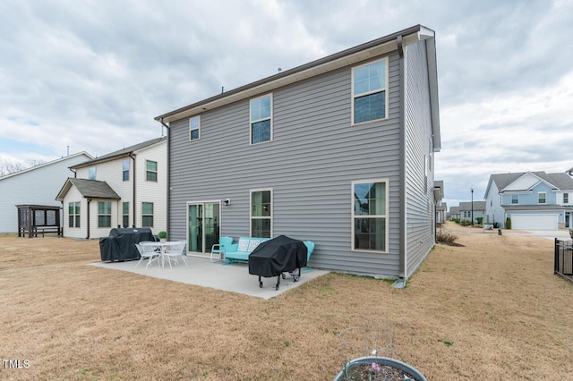 back of house featuring a lawn and a patio