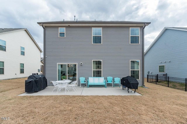 rear view of house with a patio, fence, and a lawn