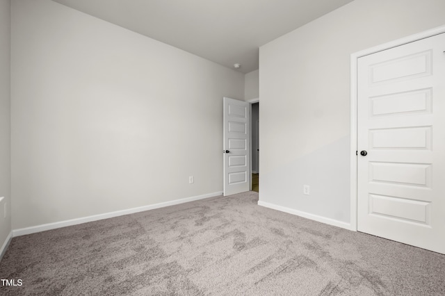 unfurnished bedroom with carpet floors and baseboards