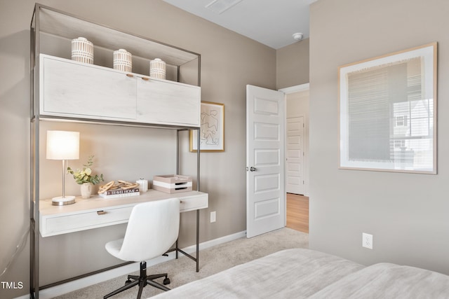 home office featuring baseboards and light colored carpet