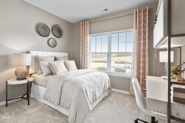 carpeted bedroom with baseboards and visible vents