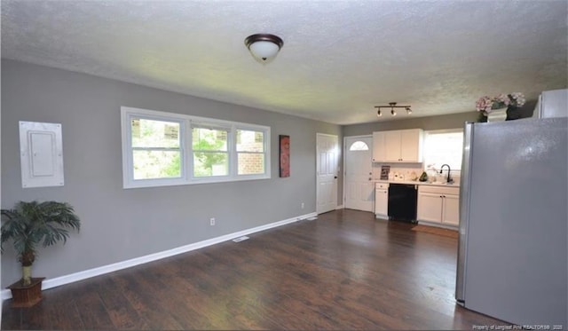 kitchen with dark wood-style flooring, light countertops, freestanding refrigerator, white cabinets, and dishwasher