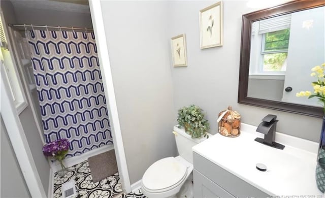 full bath featuring toilet, a shower with curtain, and vanity