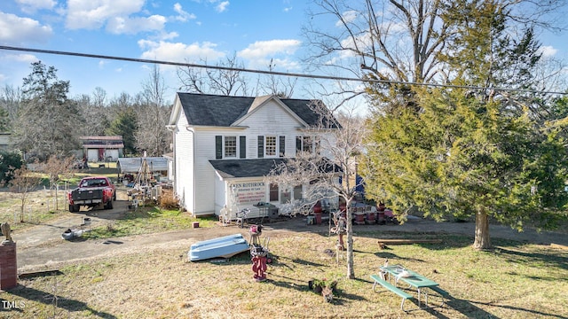 view of front of home with a shingled roof