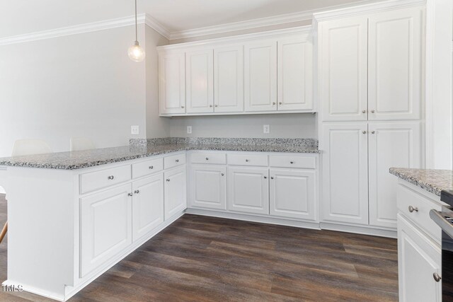 kitchen with a peninsula, dark wood-type flooring, white cabinetry, hanging light fixtures, and ornamental molding